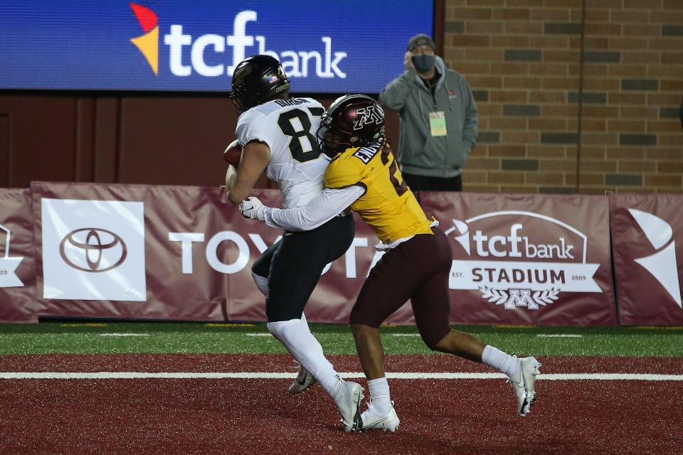 Purdue tight end Payne Durham (87) catches the ball in the end zone against Minnesota defensive back Phillip Howard (2) Friday night in Minneapolis. Durham was called for offensive pass interference on the play and the touchdown did not count. Minnesota won 34-31.