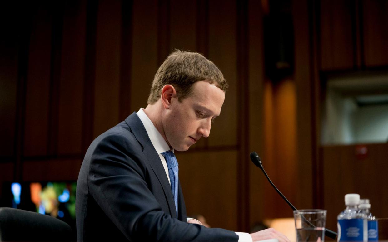 Mark Zuckerberg pauses while testifying before a joint hearing of the Commerce and Judiciary Committees on Capitol Hill in Washington - AP