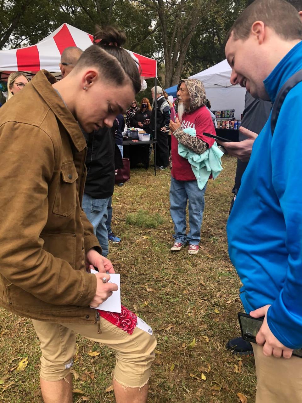 America's Got Talent Season 16 second place winner Aerialist Aidan Bryant signs an autograph at the Richard Bland College 2021 Pecan Festival in Petersburg.