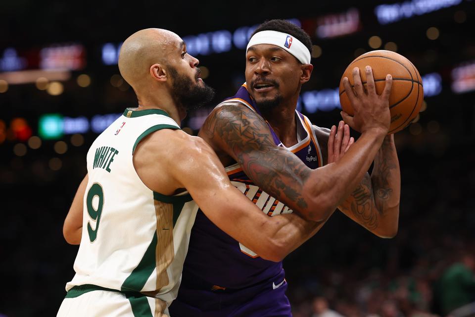 Derrick White #9 of the Boston Celtics defends Bradley Beal #3 of the Phoenix Suns during the second quarter at TD Garden on March 14, 2024, in Boston.