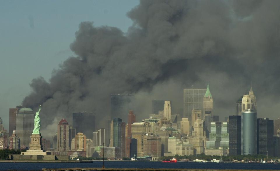 Thick smoke billows into the sky from the area behind the Statue of Liberty (AP)