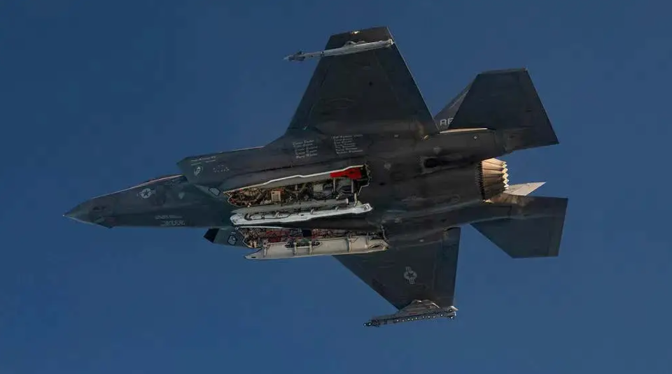 The red tail of an inert B61-12 is visible inside the bomb bay of this F-35A during a test flight. The jet also carries at least one AIM-120 AMRAAM air-to-air missile in its weapons bays. <em>U.S. Department of Defense</em>