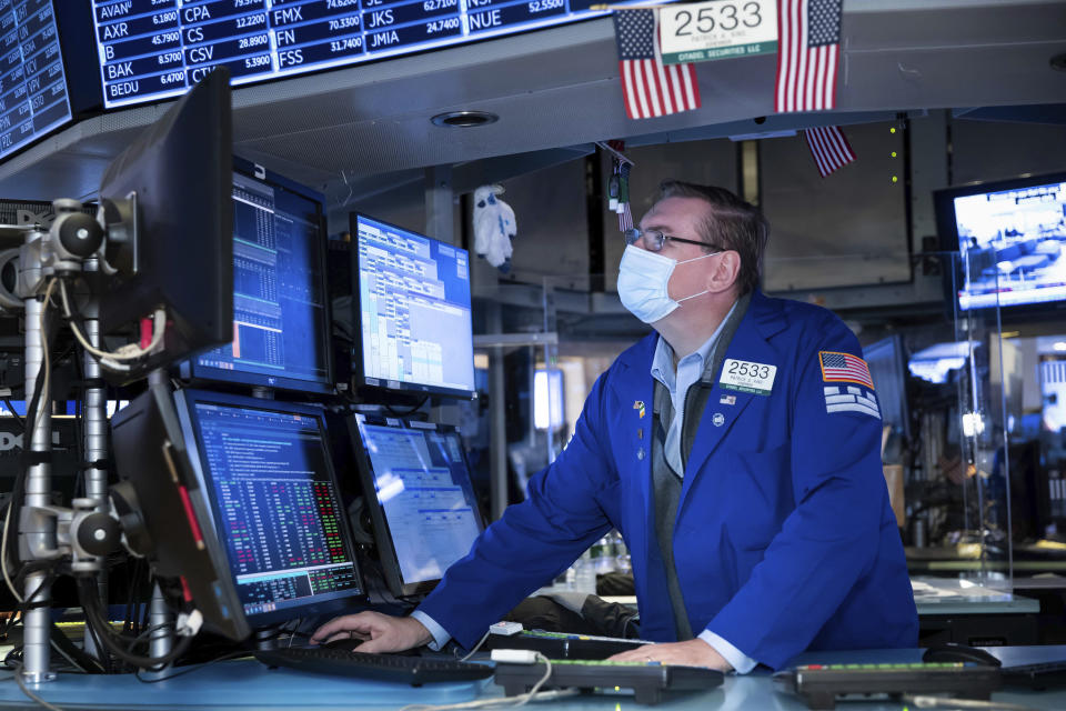 Specialist Patrick King works at the New York Stock Exchange on Monday, Nov. 23, 2020. Stocks rose in early trading Monday after investors received several pieces of encouraging news on COVID-19 vaccines and treatments, tempering concerns over rising virus cases and business restrictions. (Nicole Pereira/New York Stock Exchange via AP)