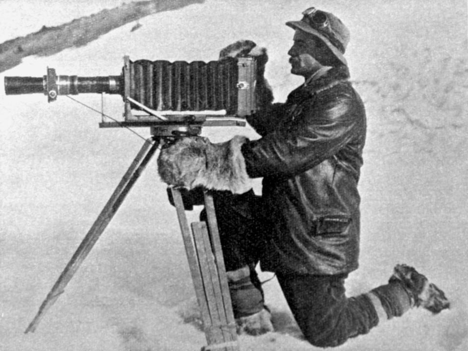 Captain Robert Falcon Scott's photographer, Herbert Ponting, at work in the Antarctic.