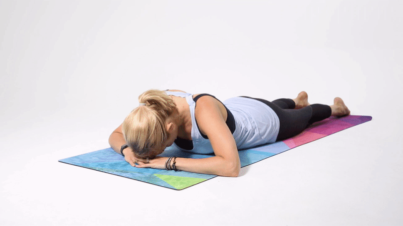 instructor demonstrating how to do a criss-cross yoga shoulder opener pose