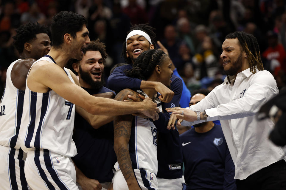 Ja Morant is swarmed by teammates after hitting the game-winning shot. (Chris Graythen/Getty Images)