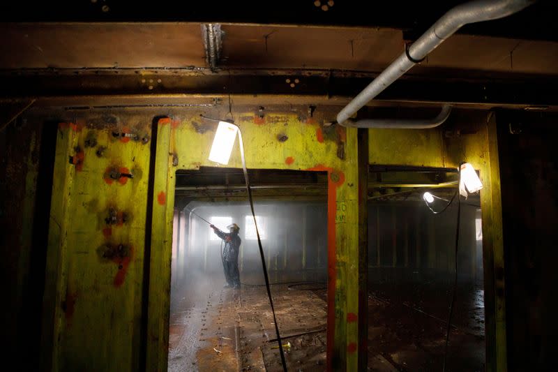 A worker cleans inside Galeb yacht in Kraljevica shipyard