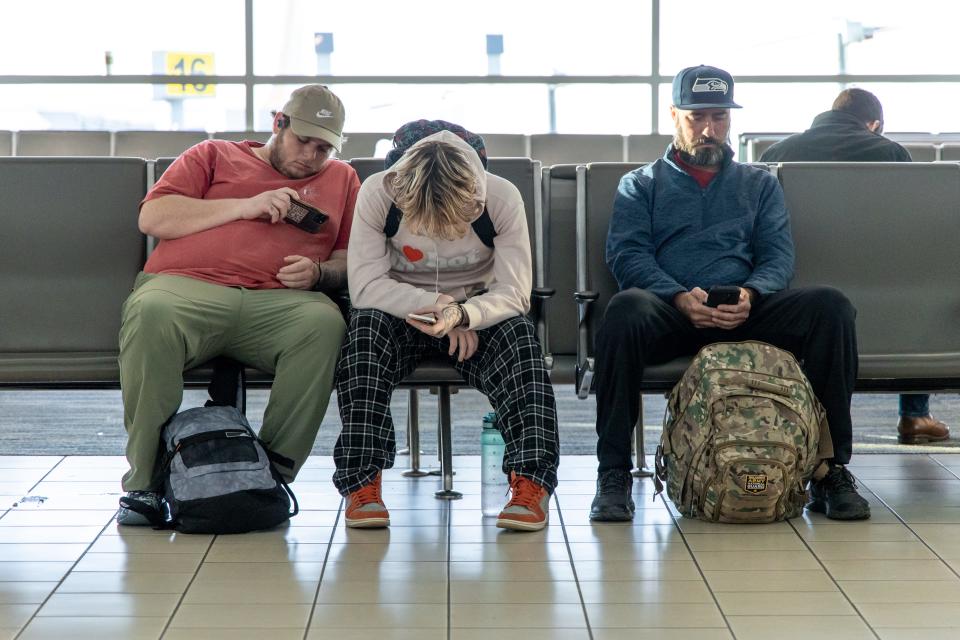 Passengers wait to board flights Wednesday at Will Rogers World Airport in Oklahoma City after the FAA had a computer outage grounding flights nationwide.