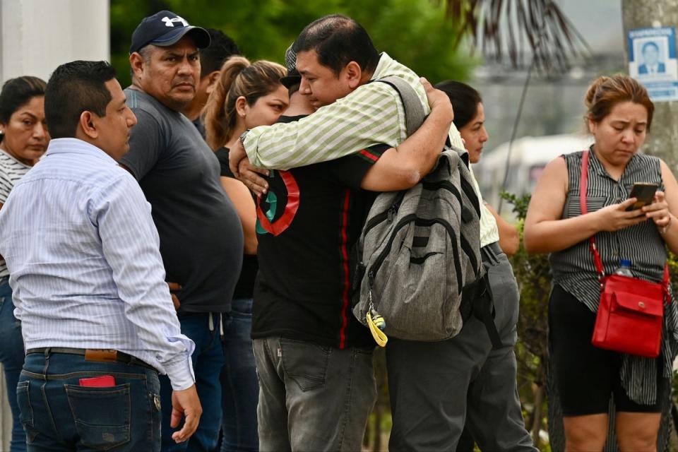 Relatives of slain prosecutor Cesar Suarez outside the morgue in Guayaquil, Ecuador (AFP via Getty Images)