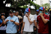 Venezuela opposition leader and Governor of Miranda state Henrique Capriles (C) reacts affected by tear gas while rallying against Venezuela's President Nicolas Maduro in Caracas, Venezuela May 1, 2017. REUTERS/Carlos Garcia Rawlins