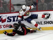 Ottawa Senators left wing Brady Tkachuk (7) collides with Florida Panthers defenseman Marc Staal (18) along the boards during first-period NHL hockey game action Monday, March 27, 2023, in Ottawa, Ontario. (Adrian Wyld/The Canadian Press via AP)