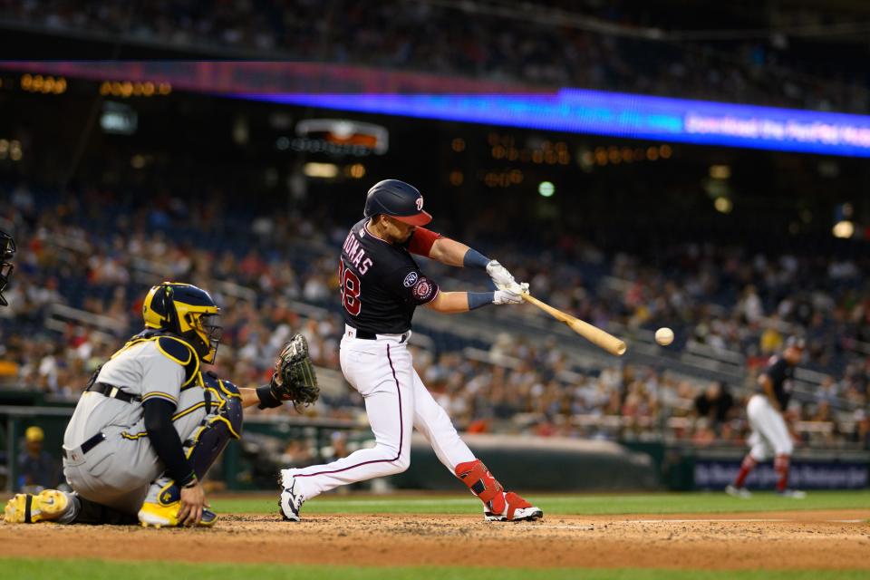 Nationals right fielder Lane Thomas hits a single off Corbin Burnes during the fifth inning Monday night in Washington.