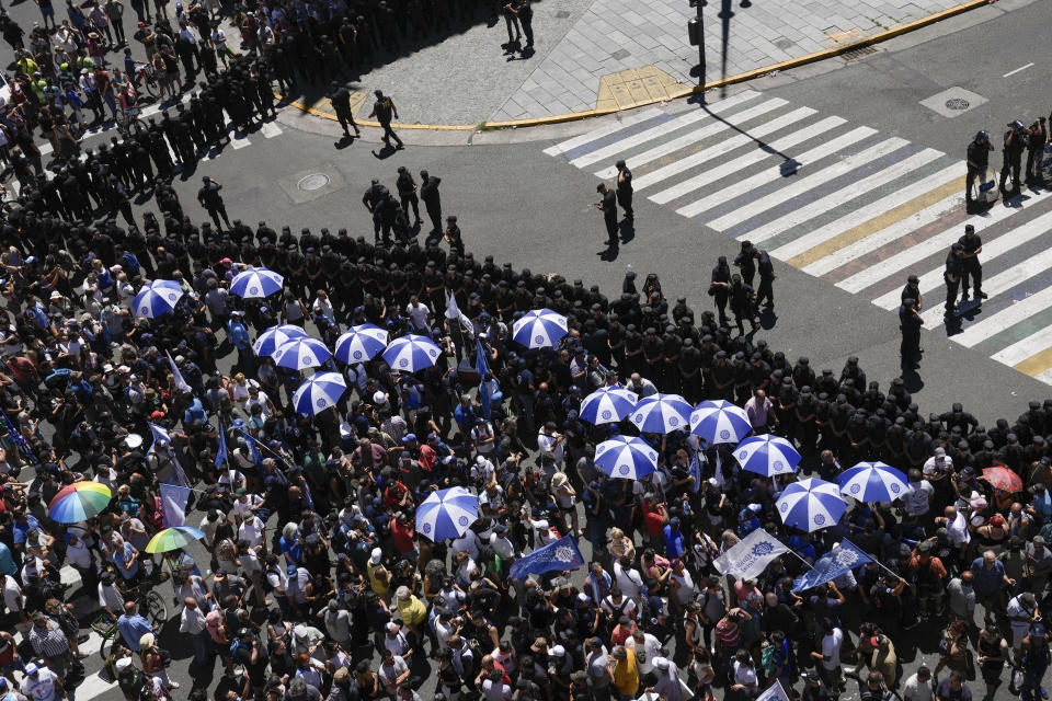 People gather outside Congress during a national strike to protest the economic and labor reforms proposed by Argentine President Javier Milei in Buenos Aires, Argentina, Wednesday, Jan. 24, 2024. (AP Photo/Rodrigo Abd)