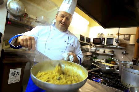 Chef Gigi Sanrocco prepares a pasta dish named "Fettucine alla Mel Gibson" in his restaurant in Matera, southern Italy April 30, 2015. REUTERS/Tony Gentile