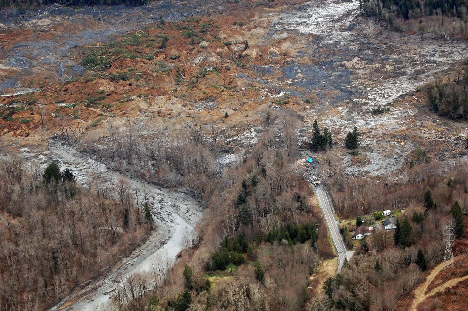 This March 22, 2014 photo, made available by the Washington State Dept of Transportation shows a view of the damage from Saturday's mudslide in Oso, Wash. At least eight people were killed in the 1-square-mile slide that hit in a rural area about 55 miles northeast of Seattle on Saturday. Several people also were critically injured, and about 30 homes were destroyed. (AP Photo/Washington State Dept of Transportation)