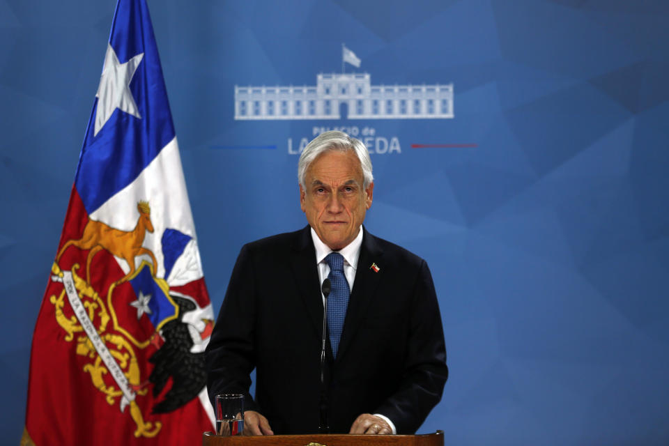 Chilean President Sebastián Piñera addresses the nation from La Moneda presidential palace, amid ongoing demonstrations triggered by an increase in subway fares in Santiago, Chile, Monday, Oct. 21, 2019. Protesters defied an emergency decree and confronted police in Chile’s capital Monday, continuing violent clashes, arson and looting that have left at least 11 dead and led the president to say the country is “at war.” (AP Photo/Luis Hidalgo)