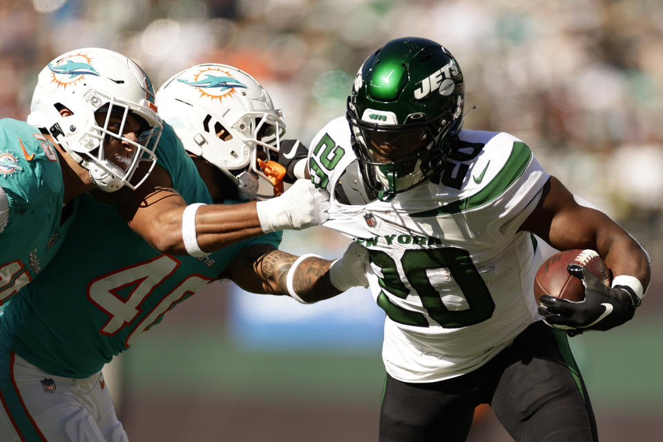 New York Jets running back Breece Hall (20) carries the ball against the Miami Dolphins during the second quarter of an NFL football game, Sunday, Oct. 9, 2022, in East Rutherford, N.J. (AP Photo/Adam Hunger)