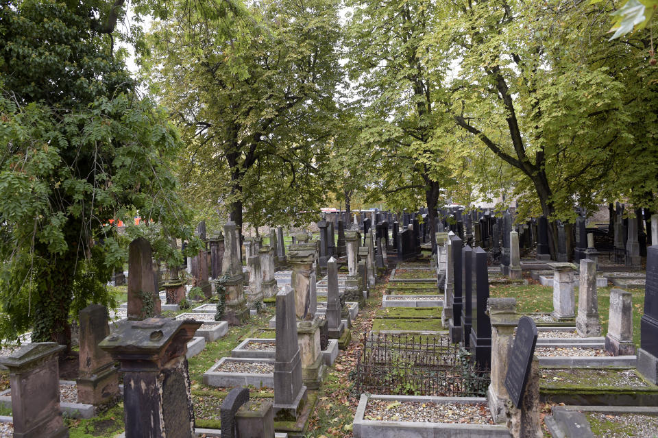 Tomb stones stand on a Jewish cemetery in Halle, Germany, Wednesday, Oct. 9, 2019. One or more gunmen fired several shots on Wednesday in the German city of Halle. Police say a person has been arrested after a shooting that left two people dead. (AP Photo Jens Meyer)