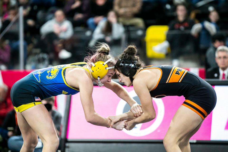 Wilton's Hannah Rogers, left, wrestles Cedar Rapids Prairie's Mackenzie Childers at 125 pounds in the finals during the IGHSAU state girls wrestling tournament, Friday, Feb. 3, 2023, at the Xtream Arena in Coralville, Iowa.