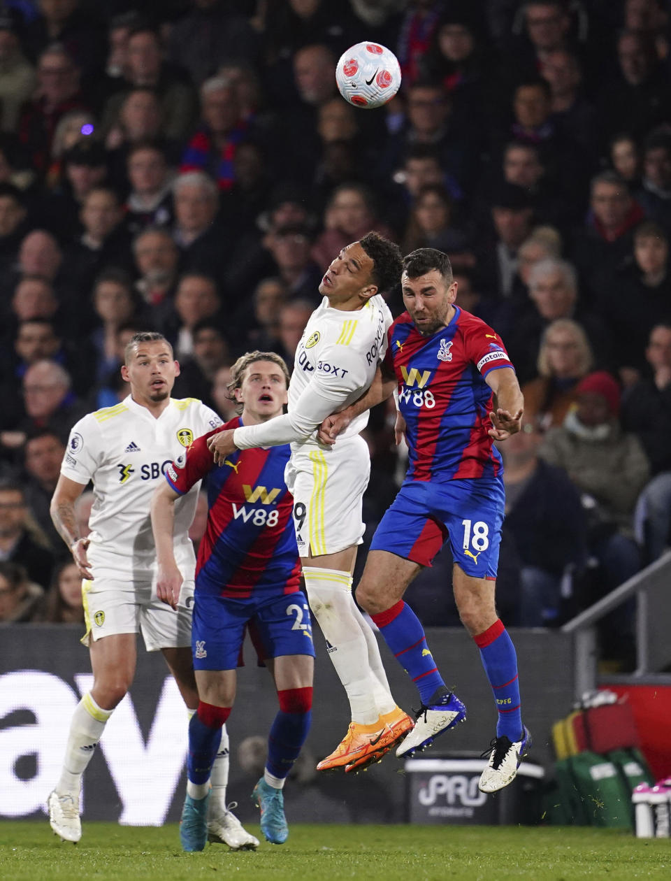 Leeds United's Rodrigo, left, and Crystal Palace's James McArthur battle for the ball during the English Premier League soccer match between Crystal Palace and Leeds United at Selhurst Park, London, Monday April 25, 2022. (John Walton/PA via AP)