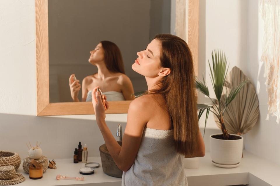 Woman-Spraying-Perfume-Stock-Photo