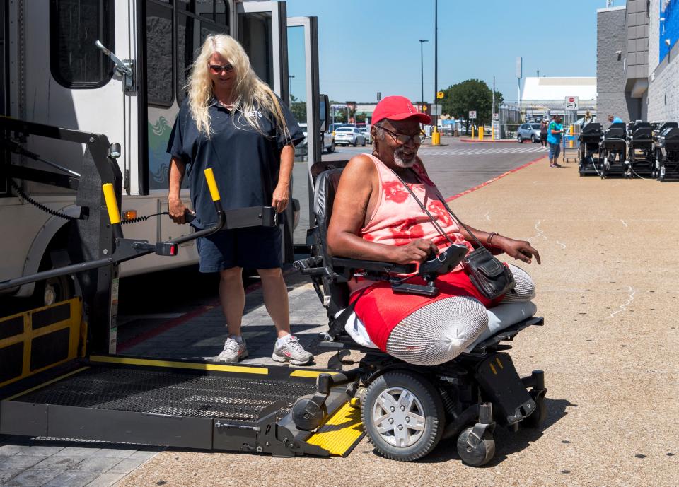 Fred Cook rolls off the ramp of a METS Mobility bus at Walmart East to grocery shop in Evansville, Ind., Tuesday morning, June 21, 2022. He has to arrange for the pick-up service to take him and his wheelchair to the grocery store weeks in advance.