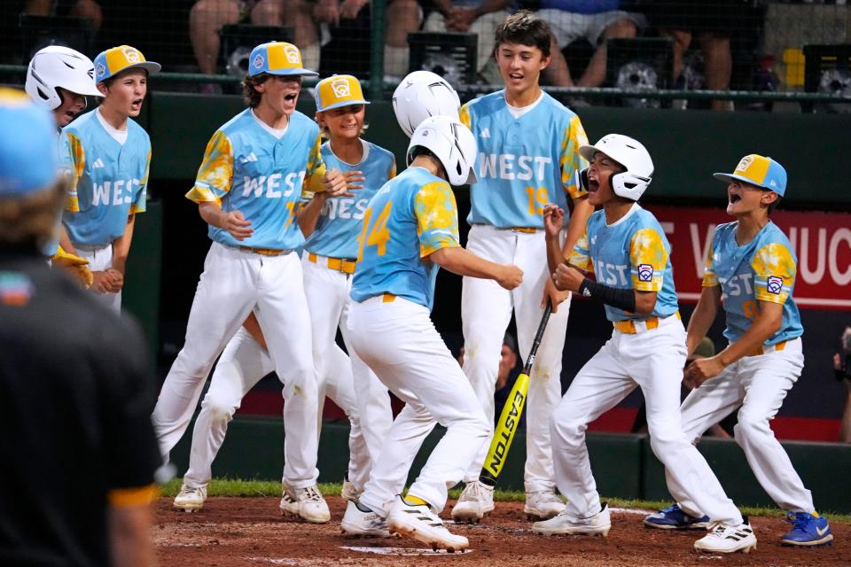 El Segundo, Calif.'s Brody Brooks (14) crosses home plate after hitting a two-run home run off New Albany, Ohio's Kevin Klingerman during the third inning of a baseball game at the Little League World Series in South Williamsport, Pa., Thursday, Aug. 17, 2023.