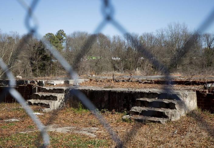 The crumbling foundations of former residences can be seen from outside the fence surrounding “Fayette Place,” the 20-acre former site of the Fayetteville St. Apartments, which is owned by Durham Housing Authority, on Tuesday, Feb. 23, 2021, in Durham, N.C.
