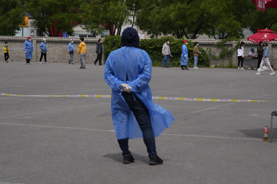 Residents line up for mass COVID-19 test on Monday, May 9, 2022, in Beijing. (AP Photo/Ng Han Guan)