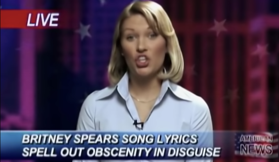 fake news reporter with the footer "Britney Spears song lyrics spell out obscenity in disguise" in the music video for the song