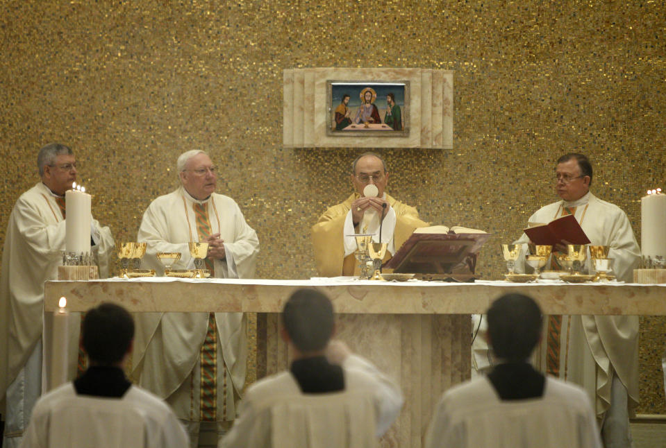 Cardinal Velasio De Paolis, second from right, flanked by Legionaries of Christ's new director general Father Eduardo Robles Gil, right, celebrates a mass in the Legion of Christ main headquarters, the Ateneo Pontificio Regina Apostolorum, in Rome, Tuesday, Feb. 25, 2014. Cardinal De Paolis celebrated his final Mass as papal delegate on Tuesday and was sent off with a round of applause from a congregation eager to take back the autonomy that was wrested away from it by Pope Benedict XVI in 2010. Benedict intervened after a Vatican investigation determined that the Legion had been infected by the influence of its founder, the late Rev. Marcial Maciel, who sexually abused his seminarians, fathered at least three children and built a cult-like system of power based on silence, deceit and obedience. (AP Photo/Riccardo De Luca)