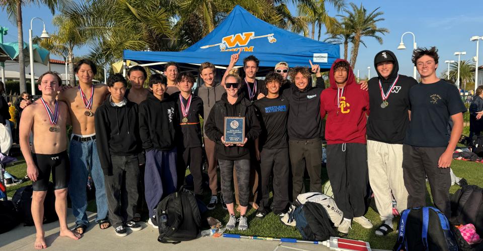 The Westlake High boys swimming team poses with the championship plaque after winning the team title at the 15th annual Ventura County Swimming Championships at Buena High.