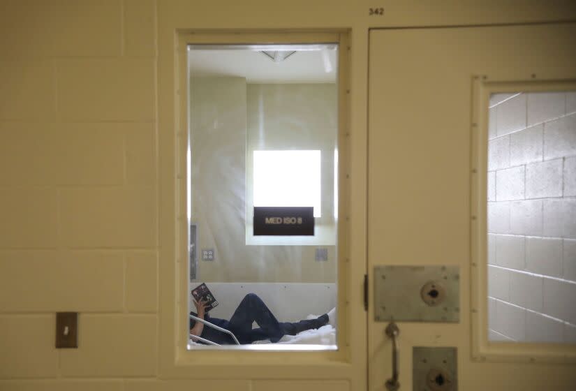 An inmate reads a book while in the infirmary at Las Colinas Women's Detention Facility in Santee, California on April 22, 2020. - Inmates and Sheriff's deputies at the prison are practicing COVID-19 measures including wearing masks, staying keeping a safe distance and doing more frequent cleaning at the facility. (Photo by Sandy Huffaker / AFP) (Photo by SANDY HUFFAKER/AFP via Getty Images)