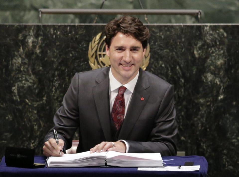 Justin Trudeau, Prime Minister of Canada, signs the Paris Agreement on climate change, Friday, April 22, 2016 at U.N. headquarters. AP Photo/Mark Lennihan