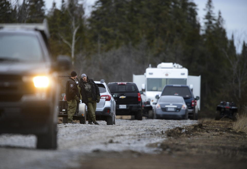 Personnel work at the site of a fatal plane crash in Kingston, Ontario, on Thursday, Nov. 28, 2019., as police and the Transportation Safety Board continue to investigate the incident. (Sean Kilpatrick/The Canadian Press via AP)