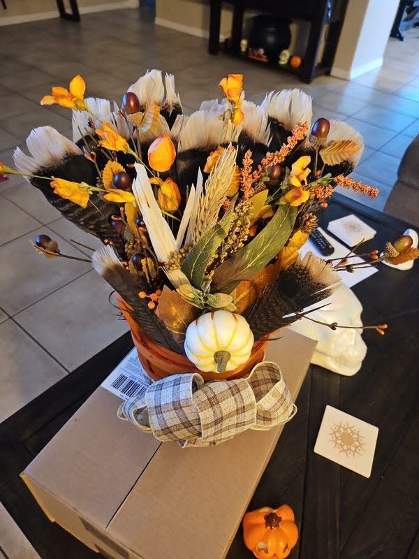A table centerpiece created by Chris Villescas's wife, using feathers from the turkey he hunted in the Apache National Forest.