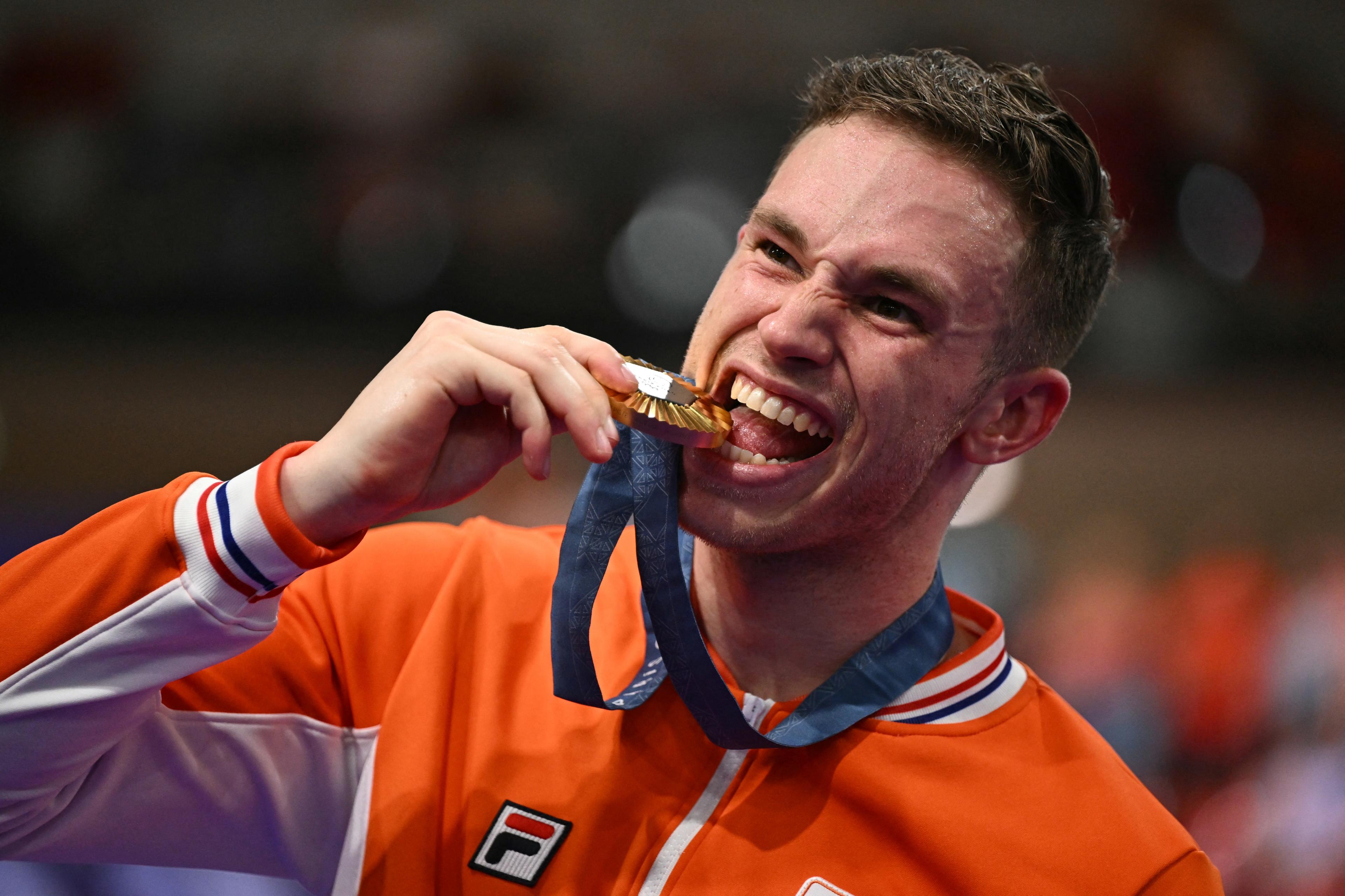 Dutch gold medalist Harrie Lavreysen poses with his medal on the podium of the men's sprint competition in track cycling at the Paris 2024 Olympic Games at the Saint-Quentin-en-Yvelines National Velodrome in Montigny-le-Bretonneux, southwest of Paris, August 9, 2024. (Sebastien Bozon/AFP/Getty Images)