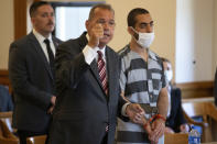 Hadi Matar, 24, right, listens as defense attorney Nathaniel Barone, center, speaks during an arraignment in the Chautauqua County Courthouse in Mayville, NY., Thursday, Aug. 18, 2022. Matar was arrested Aug. 12 after he rushed the stage at the Chautauqua Institution and stabbed Salman Rushdie in front of a horrified crowd. (AP Photo/Joshua Bessex)