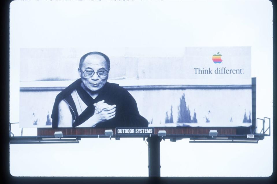 Billboard featuring the Dalai Lama with the Apple logo and slogan 