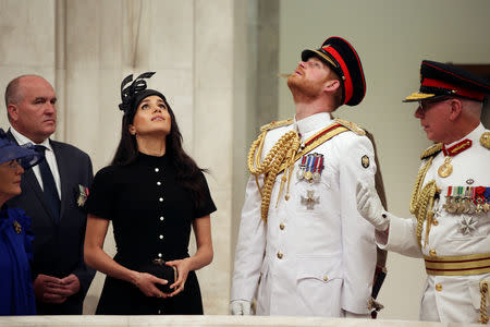 The Duke and Duchess of Sussex, Prince Harry and his wife Meghan, look upwards at the opening of the enhanced ANZAC memorial in Hyde Park, Sydney, Australia October 20, 2018. Ian Vogler/Pool via REUTERS