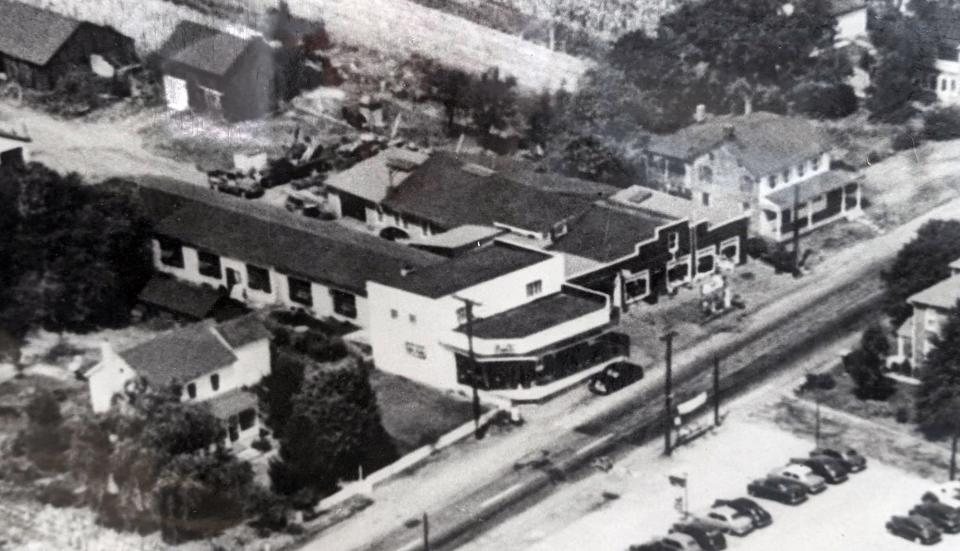 An ariel view of Beshore & Koller taken during the mid-20th century. Note the footprint of the current showroom with the white facade. The earlier building to the right of it is now a car lot and the house to the left of the current showroom building is now a service parking area and the site of the service center. The area behind the dealership, now houses, was a rural landscape at the time.
(Credit: Provided by Beshore & Koller)