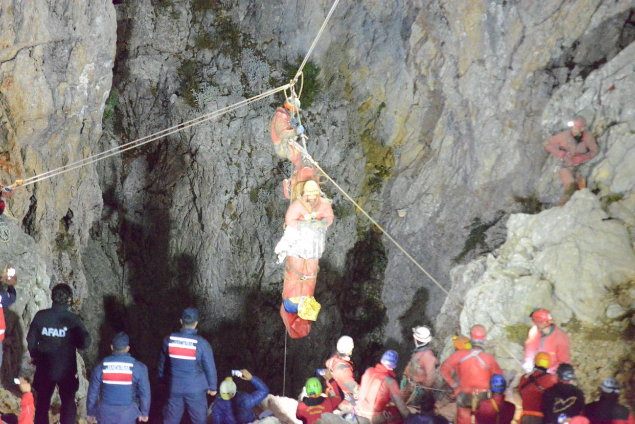 Mark Dickey (C) is lifted out after being rescued from the Morca Cave, in the Anamur district of Mersin, Turkey, 12 September 2023 (EPA)