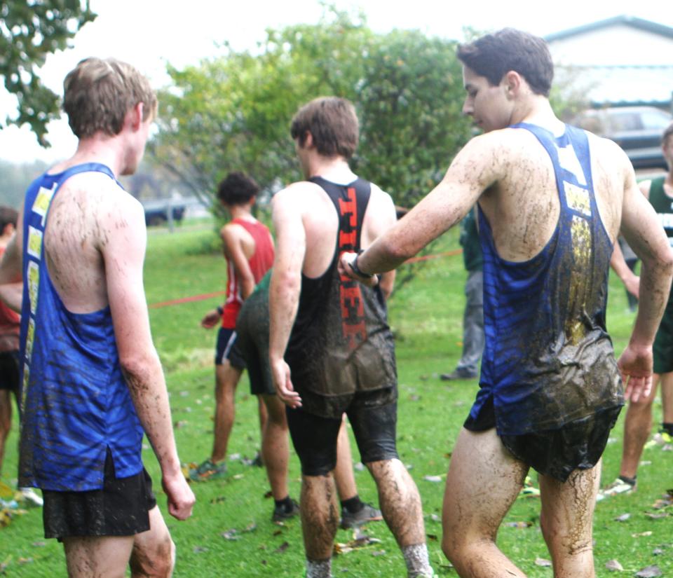 North Salem teammates Jack Fryer (l) and Connor Quadrini (r) wear part of the course after finishing the Dan Purdy Memorial Cross-Country Invitational Sept. 20, 2023 at Pawling High.