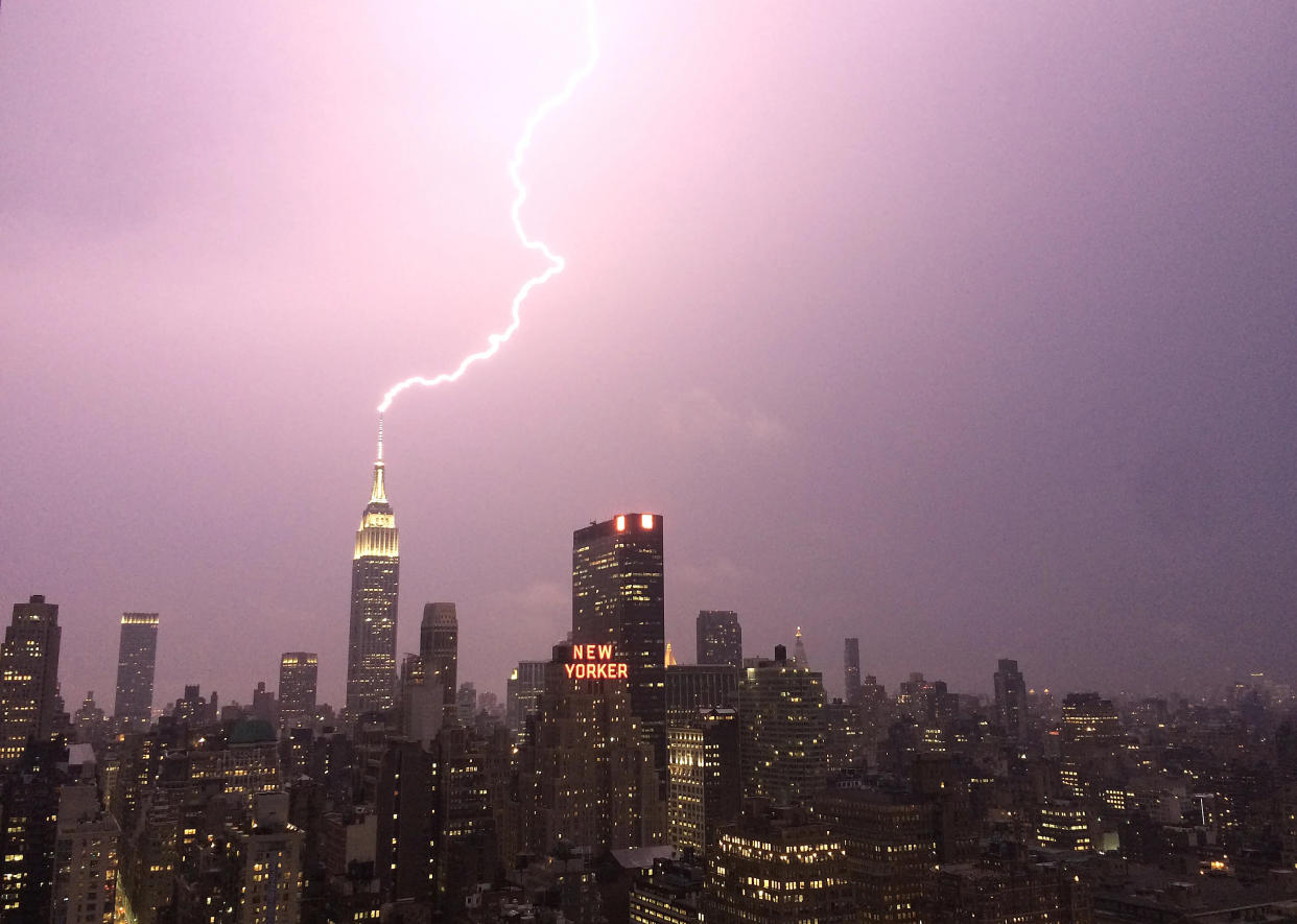 FILE - Lightning strikes the Empire State Building on July 15, 2014 in New York City.