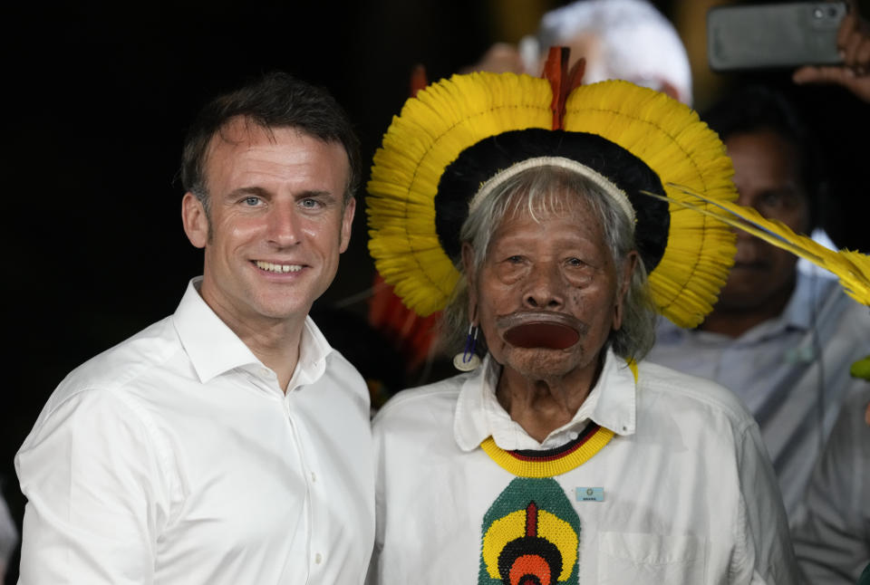 French President Emmanuel Macron, left, and Chief Raoni Metuktire poses for photos after Macron presented Chief Raoni with the French distinction, the Legion of Honor, during a ceremony on Combu Island, near Belem, Para state, Brazil, Tuesday, March 26, 2024. (AP Photo/Eraldo Peres)
