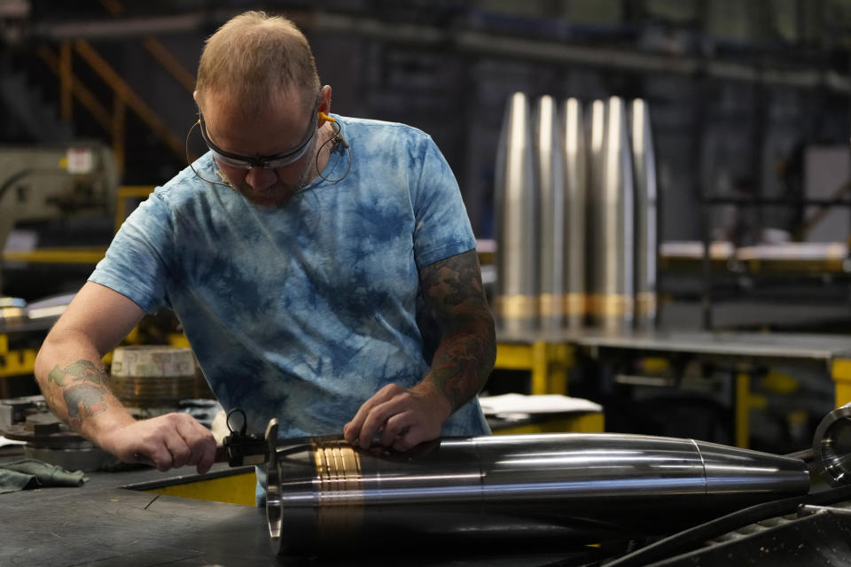 A steel worker inspects a 155 mm M795 artillery projectile at the Scranton Army Ammunition Plant, Tuesday, Aug. 27, 2024, in Scranton, Pa. (AP Photo/Matt Slocum)