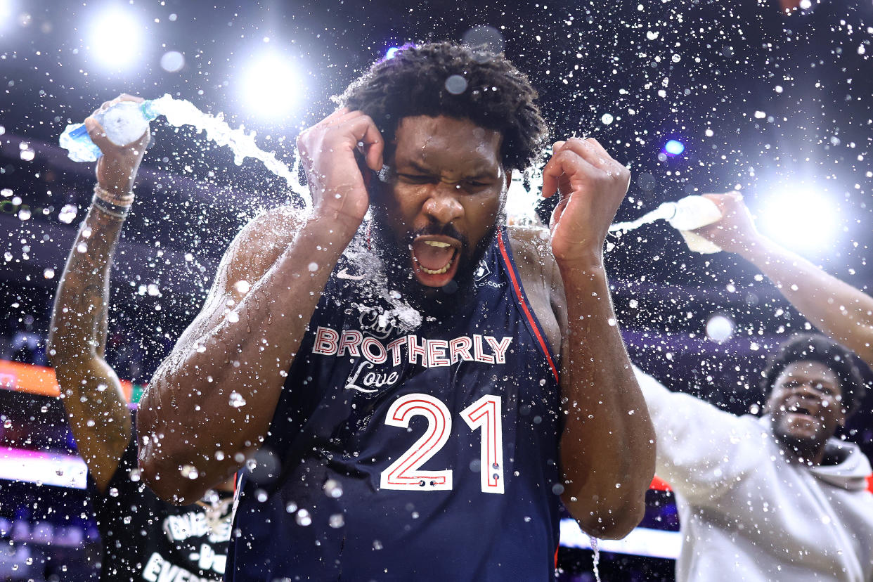 PHILADELPHIA, PENNSYLVANIA - JANUARY 22: Joel Embiid #21 of the Philadelphia 76ers reacts after being showered with water after defeating the San Antonio Spurs at the Wells Fargo Center on January 22, 2024 in Philadelphia, Pennsylvania. Embiid scored a franchise-record 70 points in the game. NOTE TO USER: User expressly acknowledges and agrees that, by downloading and or using this photograph, User is consenting to the terms and conditions of the Getty Images License Agreement. (Photo by Tim Nwachukwu/Getty Images)