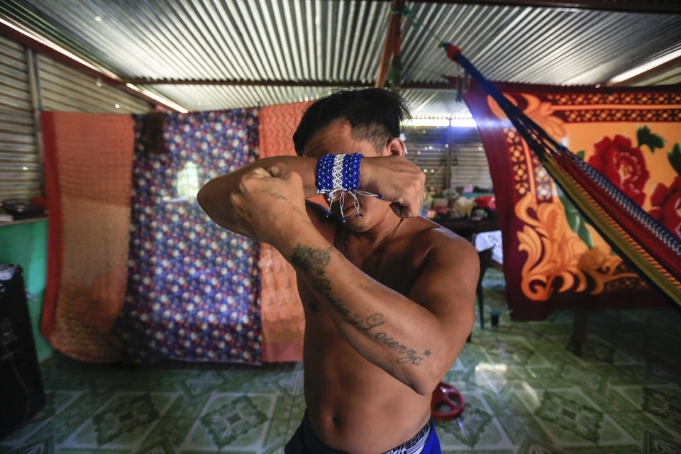 Prisoner Franklin Perez, 29, strikes a pose showing off his tattoos, one dedicated to his mother, the other to his deceased daughter, in his home after he was released to house arrest, in Managua, Nicaragua, Friday, April 5, 2019. Perez is among the 50 people released Friday who had been jailed for protesting against President Daniel Ortega's government. However charges were not dropped against the demonstrators. Instead they were for the most part transferred to a form of house arrest, short of the unrestricted freedom that the opposition has demanded. (AP Photo/Alfredo Zuniga)