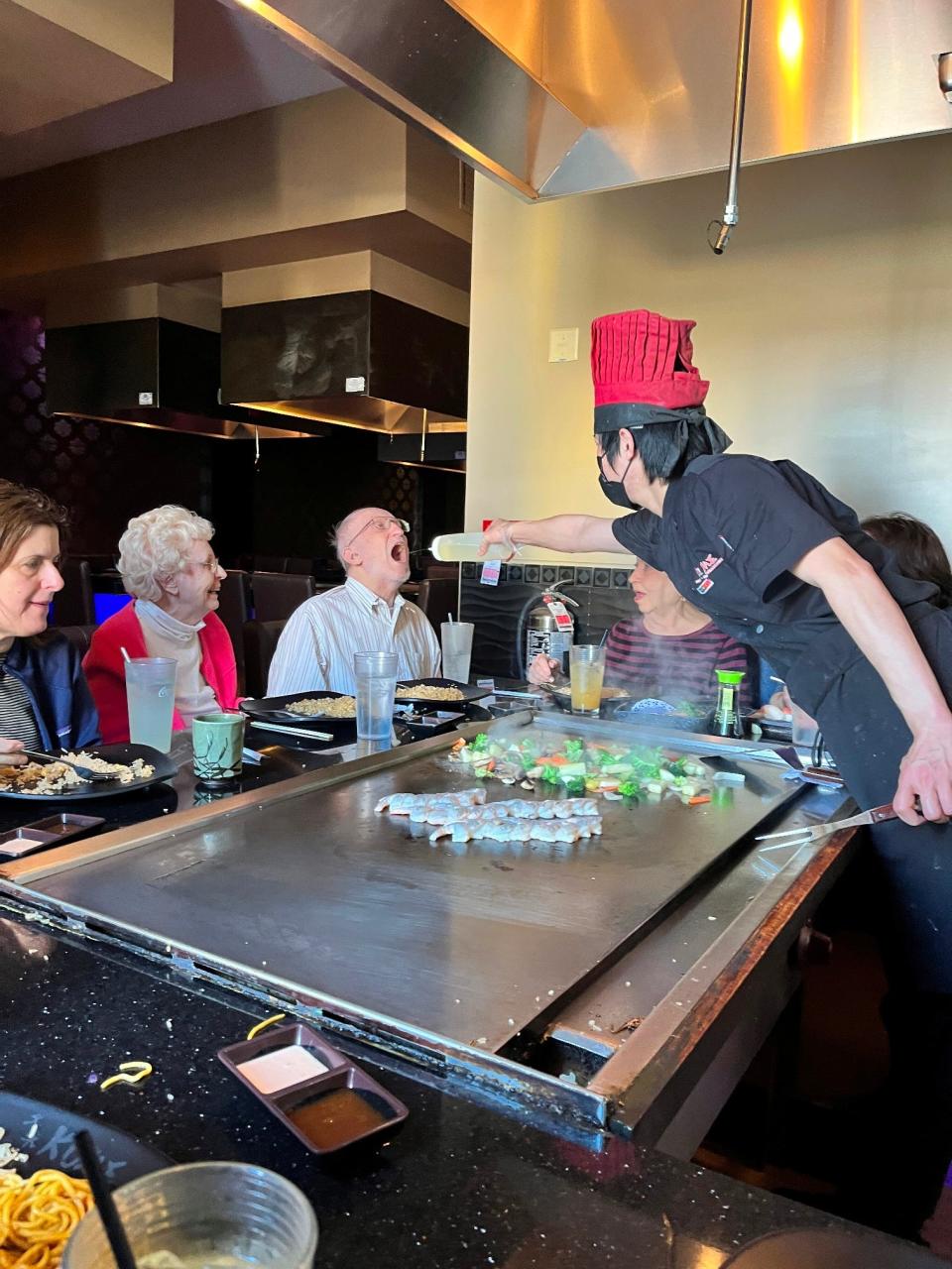 Resident Jim O'Brien tries some sake at Kume Japanese Steakhouse.