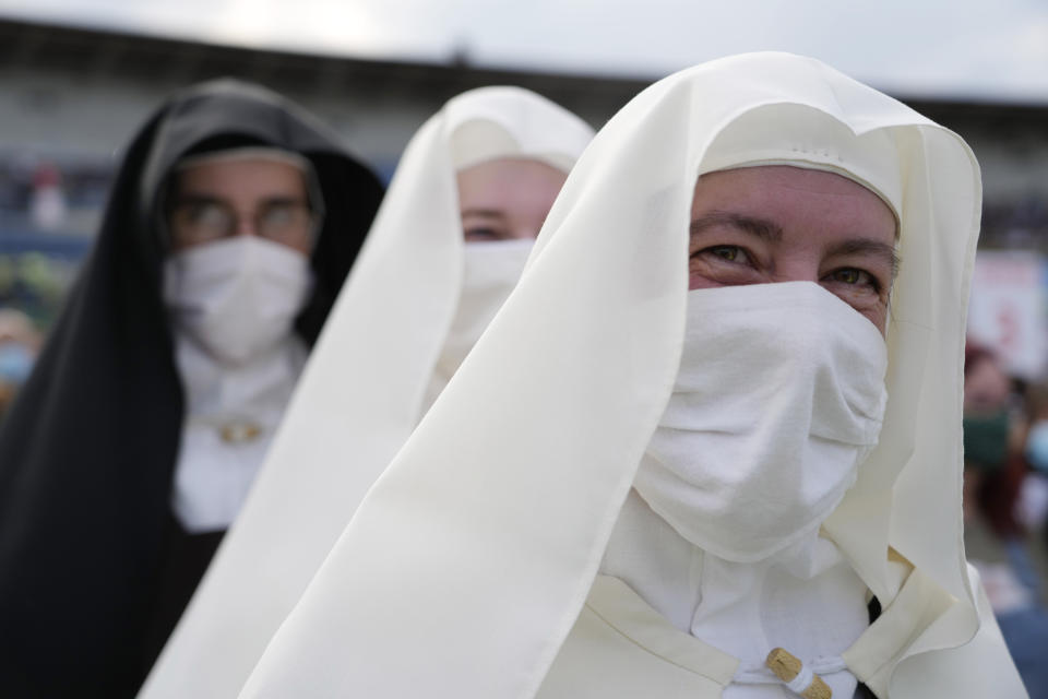 Nuns wait for Pope Francis at Lokomotiva Stadium in Košice, Slovakia, Tuesday, Sept. 14, 2021. Francis first trip since undergoing intestinal surgery in July, marks the restart of his globetrotting papacy after a nearly two-year coronavirus hiatus. (AP Photo/Gregorio Borgia)